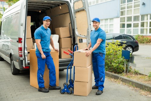 Professional team removing a sofa and other furniture from a property