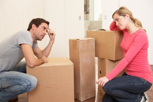 Two movers carrying furniture for a local Hammersmith relocation