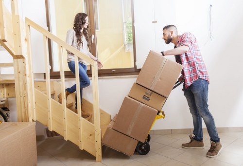 Business relocation crew handling desks and IT equipment carefully