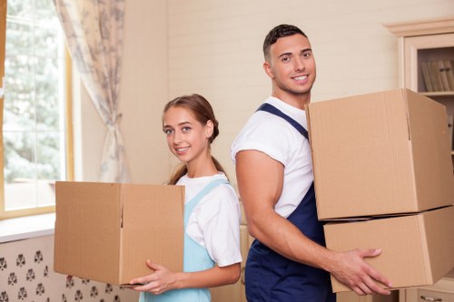 Professional movers handling furniture for a flat relocation in Hammersmith