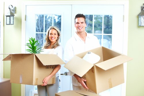 Mover handling furniture safely as part of a trained Hammersmith removals service