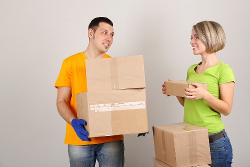 Professional movers carrying furniture through a Hammersmith property